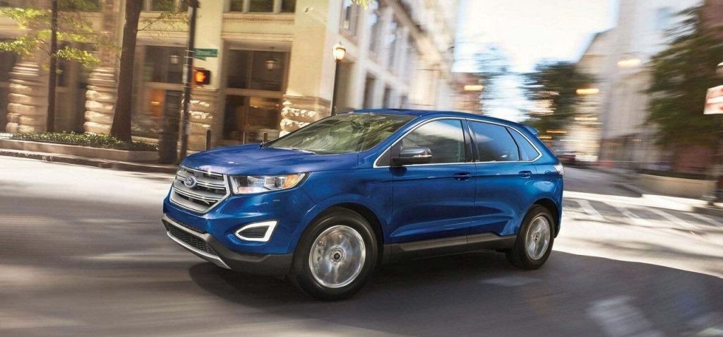 Blue Ford SUV Round A City Corner