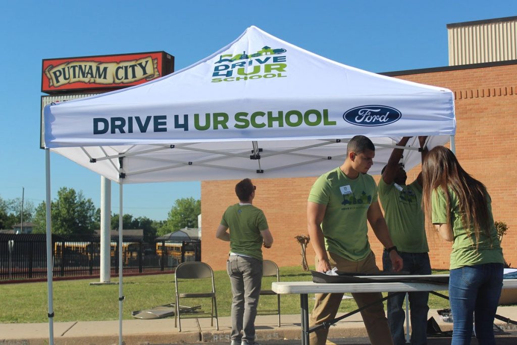 Students are setting up a Drive 4 Ur School pop up tent